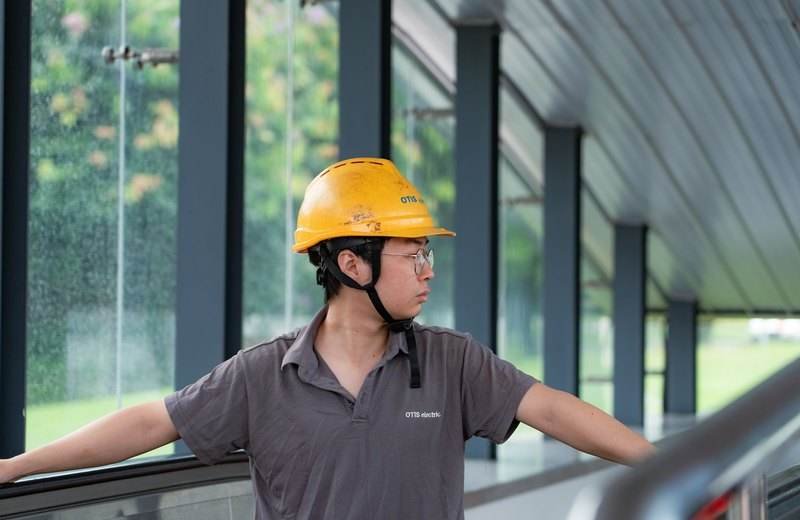 Trabajador con casco recorriendo e inspeccionando una planta industrial